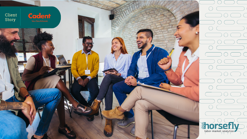 Image shows a team of people working and laughing together in an open circle discussion