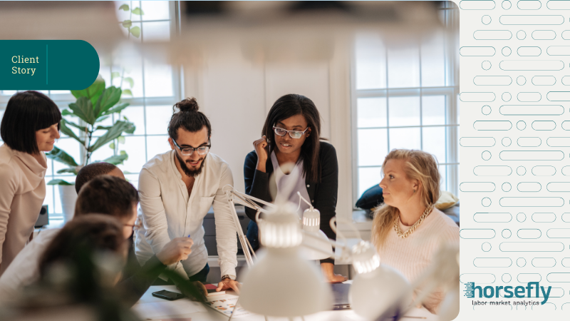 Image shows a group of colleagues working on a project over their desks