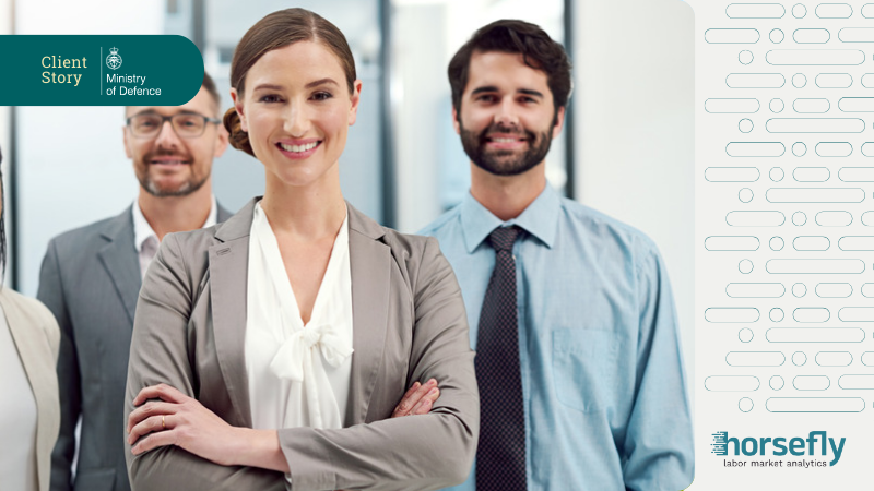 Image shows a group of business people with folded arms, smiling at the camera