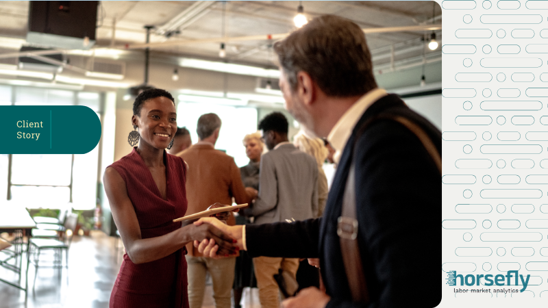 Image shows a man and woman shaking hands at a business event