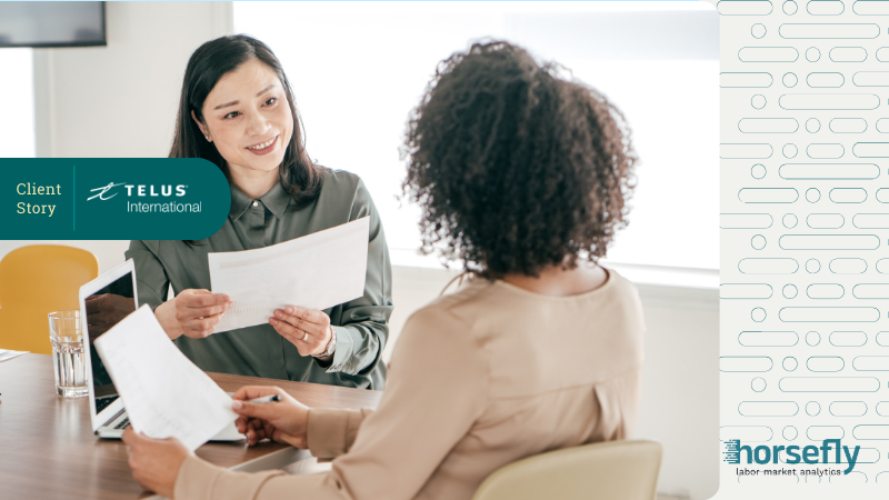 Image shows two women discussing paperwork