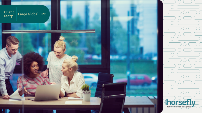 Image shows a group of workers around a table working on a project