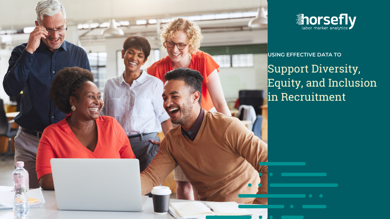 Image shows a happy team working around a laptop - for the blog - Using Effective Data to Support Diversity, Equity, and Inclusion in Recruitment